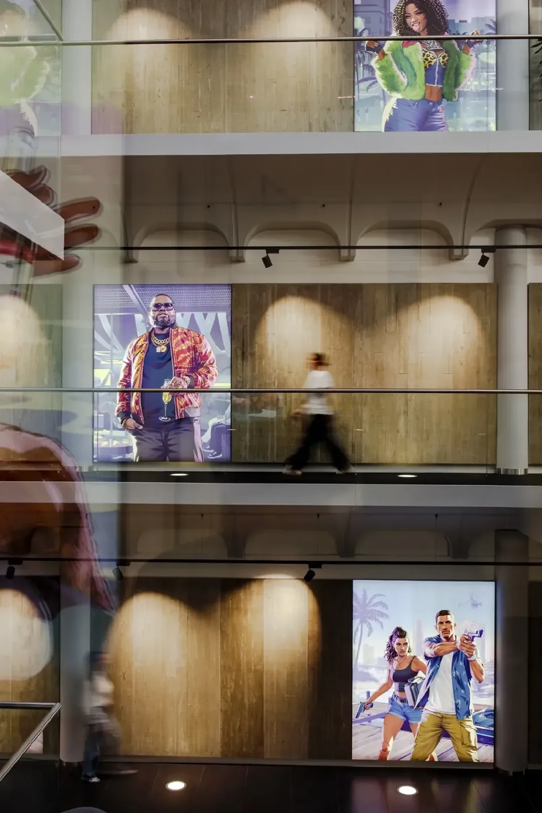 GTA 6 character posters across the floors of the Rockstar North atrium